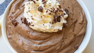 A small white bowl with chocolate pudding. There