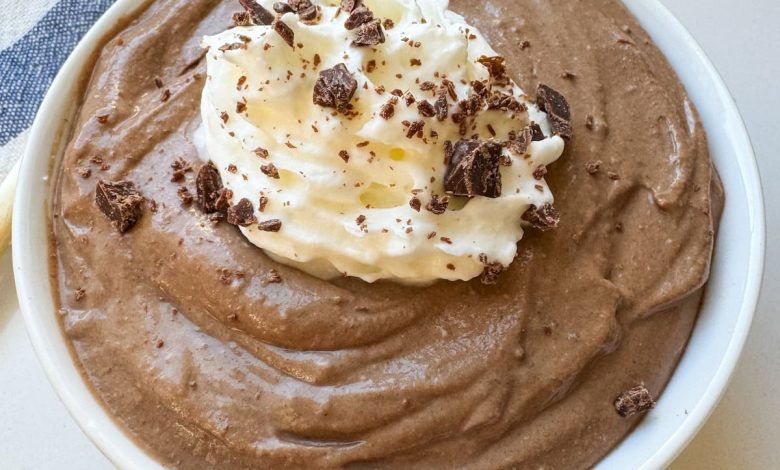 A small white bowl with chocolate pudding. There