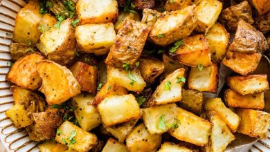 Roasted potatoes garnished with fresh parsley in a bowl.