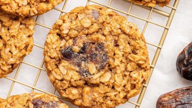 Oatmeal date cookies on a gold wire cooling rack.