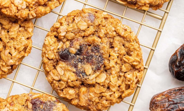 Oatmeal date cookies on a gold wire cooling rack.