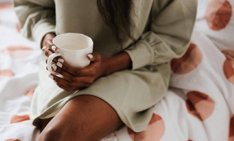 A woman drinking in bed