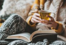 Woman drinking tea in bed.